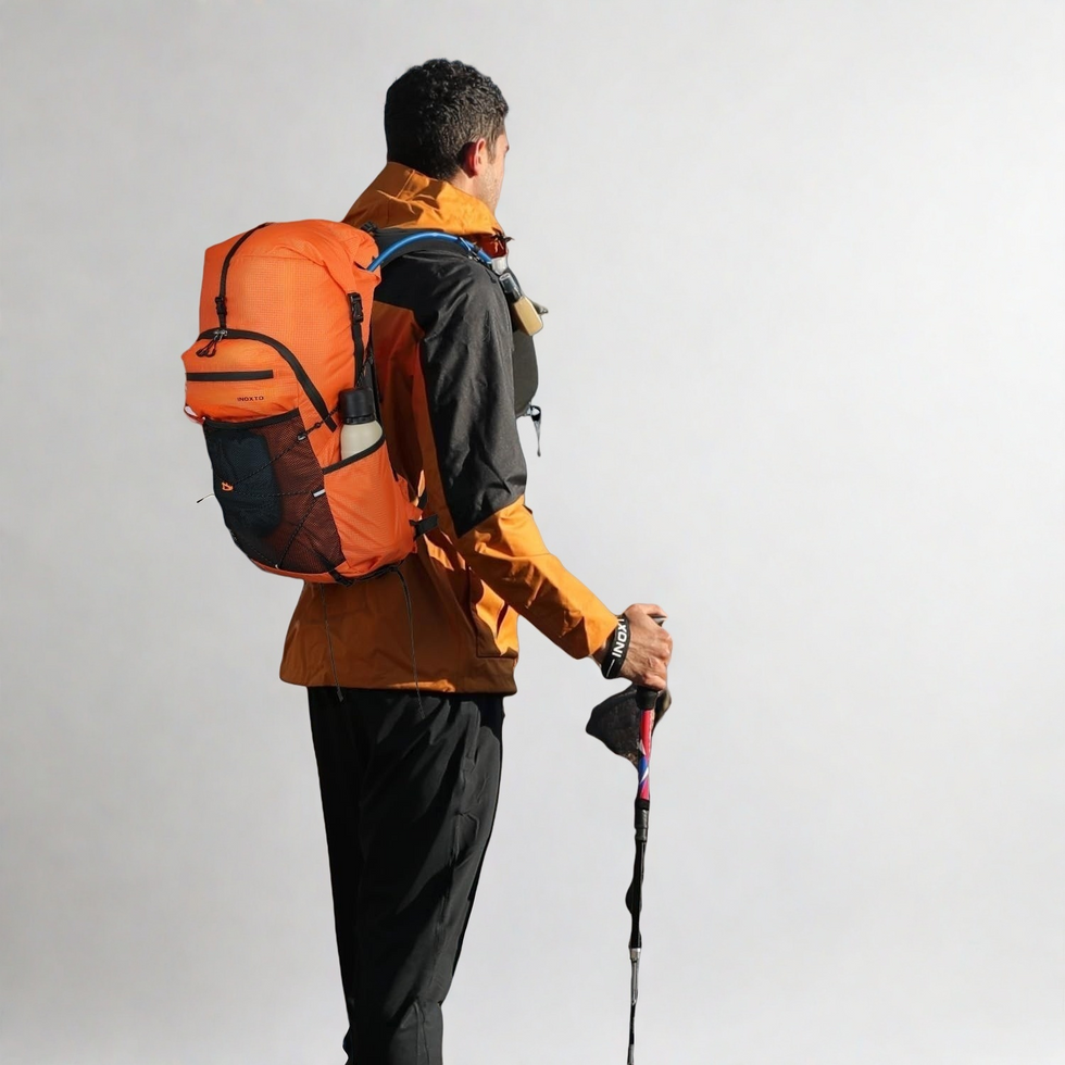 Rear view of the Tellus pack worn with trekking poles